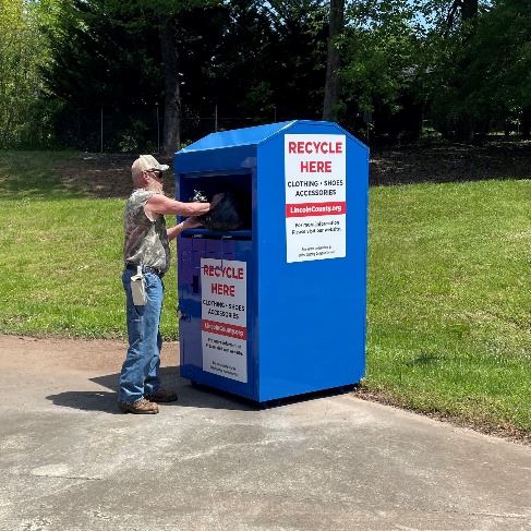 Resident Placing Items in Textile Bin